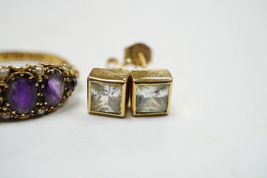 An 18ct and nine stone simulated diamond set cluster ring, a modern 18ct gold and diamond set square cluster ring, a Victorian 15ct gold, amethyst and seed pearl set half hoop ring, two pairs of 9ct and gem set ear studs